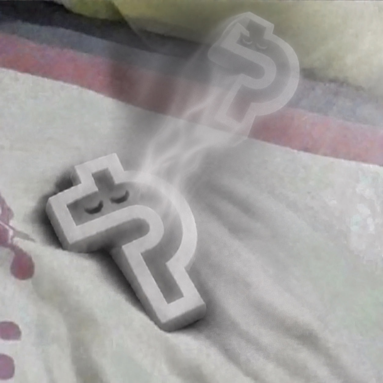 Paid Aura resting on a blanket with a ghost-like aura rising above it